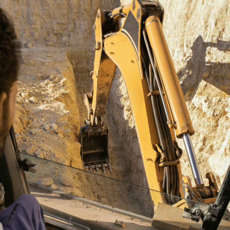 man using an excavator for digging on day light